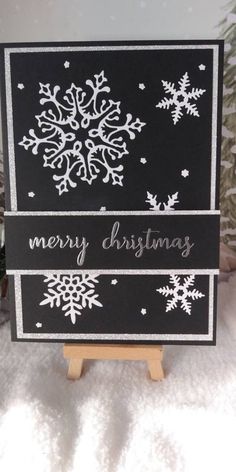 a black and white christmas card with snowflakes