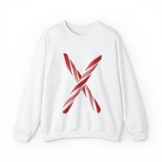 Make a Sweet Statement with our Unisex Candy Cane Letter Crewneck Sweater! Elevate your festive fashion with our Candy Cane Letter Crewneck Sweater. This delightful sweater combines the warmth and comfort you crave during the winter months with a charming, personalized touch. 🍭 Candy Cane Initial: The star of the show is a striking, candy cane-inspired initial letter emblazoned on the front. It's a deliciously festive way to express your unique style and celebrate the holiday season. ❄️ Cozy Co Casual Holiday Sweater With Graphic Print, White Letter Print Sweatshirt For Winter, White Letter Print Tops For Winter, Casual Crew Neck Holiday Sweater, Cozy White Sweater For Holidays, White Crew Neck Top For Winter, White Graphic Print Sweatshirt For Winter, White Sweatshirt For Fall Holiday, Casual Holiday Sweater With Crew Neck