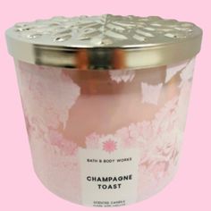 a candle that is sitting on top of a pink background with the words champagne toast printed on it