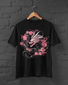 Elevate your style with our Sakura Dragon T-Shirt, a captivating fusion of Japanese and Anime aesthetics. This Japanese Tshirt features a beautiful Sakura Print, seamlessly blending the elegance of cherry blossoms with the mystique of a dragon. Perfect for Anime enthusiasts, this unique piece captures the essence of Anime Aesthetic fashion. Embrace the charm of this Japanese Dragon Tshirt, adding a touch of cultural and mythical allure to your wardrobe. Let your fashion express your love for bot Harajuku Style T-shirt With Sublimation Print, Harajuku Crew Neck T-shirt With Sublimation Print, Pink Crew Neck T-shirt With Anime Print, Pink Anime Print T-shirt, Pink Cotton Anime T-shirt, Pink Anime Cotton T-shirt, Black Harajuku T-shirt With Sublimation Print, Sakura Dragon, Aesthetic Mode