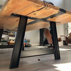 a wooden table sitting on top of a hard wood floor