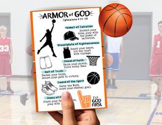 a hand holding up a basketball card with information about armor of god written on it