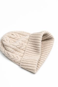 a white knitted beanie on a white background