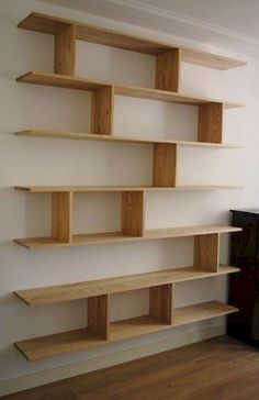 a living room filled with lots of wooden shelves