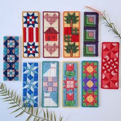 nine handmade bookmarks with different designs on them and one plant in the foreground