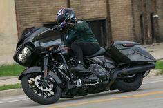 a man riding on the back of a black motorcycle