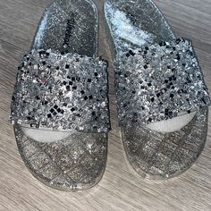 Jeweled Sandals, New Never Worn, Great Condition, Perfect For Night Out Or Occasion. Fits Like A Size 7.5 Glitter Round Toe Jelly Sandals For Party, Silver Slide Sandals For Beach, Silver Slide Sandals For The Beach, Open Toe Glitter Sandals For Beach, Silver Round Toe Flip Flops For Party, Silver Open Toe Flip Flops For Party, Flat Synthetic Jelly Sandals For Party, Party Silver Synthetic Flip Flops, Silver Flip Flops For Summer Parties