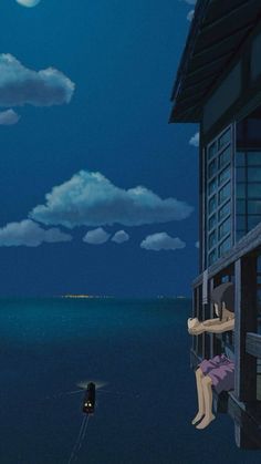 a person sitting on a ledge looking out at the ocean with a full moon in the sky