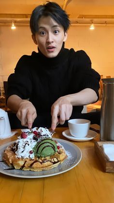 a man sitting at a table with a plate of food