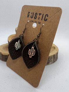 Take a look at our handcrafted, western cactus earrings!  These one-of-a-kind accessories will give your outfit a unique, eye-catching touch. The high-quality leather is lightweight and comfortable for all day wear. Whether you're going out on the town or just want something special, they make a great gift for any occasion. All earrings come with clear earring backs which are recommended for wear. Adjustable Southwestern Brown Earrings, Nickel-free Adjustable Western Earrings, Adjustable Nickel-free Western Earrings, Nickel-free Western Style Earrings, Rustic Handmade Jewelry For Western-themed Events, Western Cactus, Earrings Western, Cactus Earrings, Clear Earrings