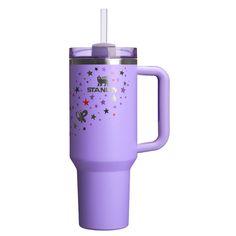 a purple travel mug with stars and unicorns on it is shown in front of a white background