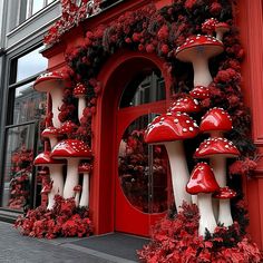 red and white mushroom decorations on the side of a building