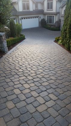 a brick driveway in front of a house