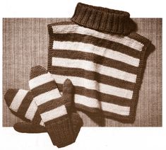 a knitted sweater and mittens are sitting next to each other