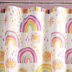 a shower curtain with rainbows and sun on it