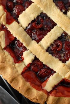 a close up view of a pie with cherries on it's crusts