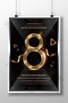 a black and gold poster with the number eight in it's center, hanging from strings