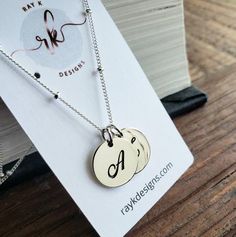 a timeless sterling silver script letters charms hang from elegant sterling silver satellite chain. all findings are sterling silver. 16'' with 2'' extender.sterling silver disc-13mm*only available in sterling silver***Please indicate the following information in the "message to seller" box at the checkout..1. 2 initials of your choicehere's more personalized options for your bridal party.http://www.etsy.com/shop/thejewelrybar?section_id=7033278 Custom Name Sterling Silver Jewelry For Best Friend, Silver Sterling Name Necklace For Anniversary, Silver Sterling Silver Name Necklace For Anniversary Gift, Silver Sterling Silver Name Necklace For Anniversary, Silver Initial Necklace In Sterling Silver, Sterling Silver White Gold Initials Name Necklace, Silver Jewelry With Initials For Anniversary Gift, Silver Jewelry With Initials For Anniversary, Monogram Sterling Silver Jewelry For Mother's Day