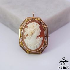 "Metal: 10k Yellow Gold Weight: 6.12 grams Measurements: 1.15\" Long; 0.92\" Wide Shell: Carnelian *Expertly hand-carved with high relief, this beautiful carnelian shell cameo brooch features an image of a smiling woman looking off to the right with her hair tied up. The piece is set into an ornately designed filigree 10k white gold bezel. This outstanding Victorian cameo is in beautiful condition, with some wear. The clasp works nicely. A truly extraordinary addition to any collection, this spe Carved Yellow Gold Brooches, Heirloom Style Carved Brooch For Gifts, Heirloom Carved Brooches As Gift, Ornate Carved Collectible Brooches, Victorian Cameo, Smiling Woman, Tacoma Wa, Aesthetic Pastel, Woman Looking