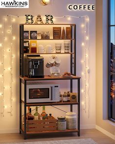 a coffee bar with lights on the wall behind it and an open shelf filled with drinks