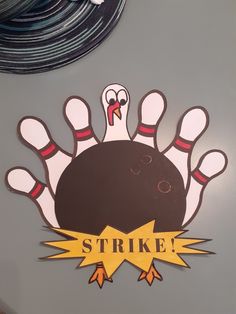 there is a sticker on the wall that says strike with bowling pins coming out of it