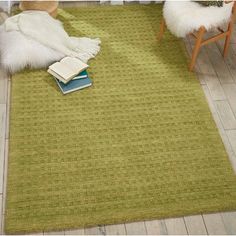 a green rug on the floor in a living room