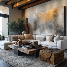 a living room filled with furniture and a large painting hanging on the wall above it