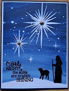 a christmas card with an image of a person and a dog in the snow, surrounded by stars