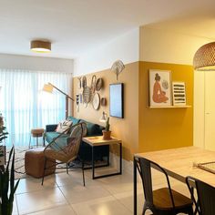 a living room filled with furniture and a flat screen tv on top of a wooden table