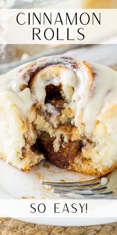 cinnamon roll with icing on top sitting on a white plate next to a fork