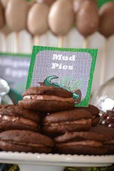 chocolate cookies stacked on top of each other in front of a sign that says mud pies