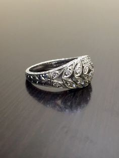 DeKara Designs Collection Metal- 90% Platinum, 10% Iridium.Stones- 24 Round Diamonds, G Color VS1 Clarity, 0.41 Carats.A true masterpiece handmade hand engraved 90 percent platinum ring/band.  The ring has 24 diamonds with 18 of them being pave set and 6 of them bezel found on the side of the rings top gallery, all with G color and VS1 clarity totaling to .41 carats.  The ring is entirely hand engraved and also double mili grained on the sides and all throughout the top.  This could be a great a White Engraved Diamond Ring, Engraved White Gold Diamond Ring In Platinum, Luxury Engraved White Gold Diamond Ring, Luxury Engraved Ring With Intricate Design, Engraved White Gold Diamond Promise Ring, Engraved White Gold Promise Ring, Intricate Engraved Promise Ring, Luxury Rings With Intricate Design, Heirloom Engraved Diamond Ring