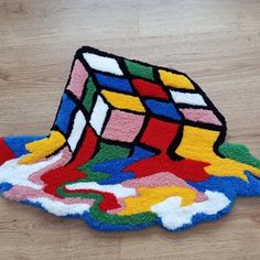 a multicolored rug with a rubik cube on it's back end