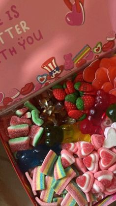 a pink box filled with lots of candy