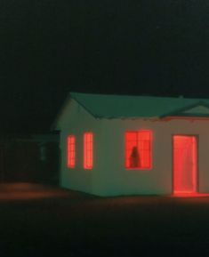 a white house with red lights in the dark