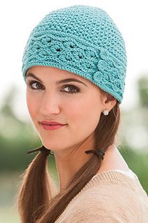 a woman wearing a blue crochet hat