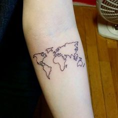 a small world map tattoo on the arm