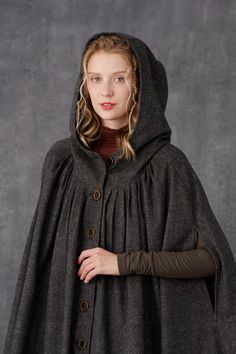 Gothic Hooded Winter Cape, Medieval Style Outerwear With Buttons For Fall, Medieval Style Fall Outerwear With Buttons, Medieval Fall Outerwear With Buttons, Winter Cape For Costume Events, Winter Costume Cape With Long Sleeves, Winter Long Sleeve Cape For Costume, Gothic Cape For Larp In Fall, Witchy Outerwear For Fall Costume