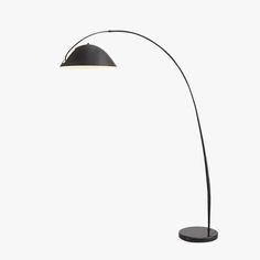 a black floor lamp with a white light on it's side and a round base