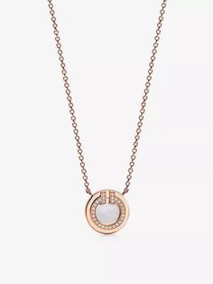 "Clean, streamlined lines and graphic detail are celebrated with the Tiffany T collection from Tiffany & Co., with the label's logo transformed into utterly new shapes while remaining recognisable for fans. This Two Circle pendant necklace is no different; this time, the ""T"" is rendered as a diamond-studded swish, a twinkling border between rose gold and mother-of-pearl discs. Timeless in its simplicity, it's one to be cherished and passed down." Tiffany Co Necklaces, Tiffany T, Bridal Shoes Flats, Circle Pendant Necklace, Bag Boys, Slippers For Girls, Tiffany And Co, Pearl Pendant Necklace, Rose Gold Necklace