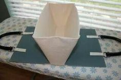 a white vase sitting on top of a table next to a pair of black cords