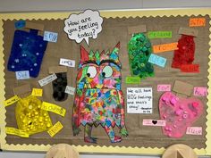 a bulletin board with different types of paper and buttons on it, including an owl