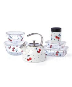 a tea pot and four bowls with cherries painted on the sides, all in different designs