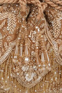 Gold, silver velvet potli bag with intricate tone-on-tone sequin, cutdana, bead embroidery in floral pattern and crystal tassel drops. - Aza Fashions Festive Sequined Bags For Reception, Glamorous Embellished Potli Bag For Reception, Luxury Hand Embellished Potli Bag For Reception, Glamorous Embellished Potli Bag For Festive Occasions, Glamorous Embellished Potli Bag For Festive Season, Glamorous Embellished Festive Potli Bag, Festival Mirror Work Potli Bag For Reception, Luxury Beaded Potli Bag For Parties, Luxury Embellished Potli Bag For Evening