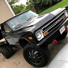 a black truck parked in front of a house