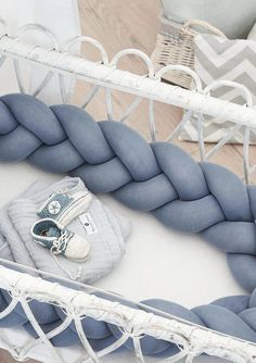 a baby crib with blue and white accessories