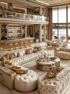 a large living room filled with lots of white couches and gold accents on the walls