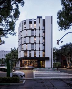 a tall white building sitting on the side of a road