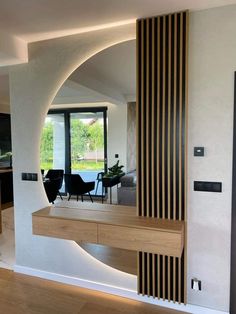 a modern living room and dining area with wood accents on the walls, along with an open floor plan