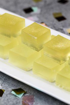 several cubes of yellow ice on a white plate